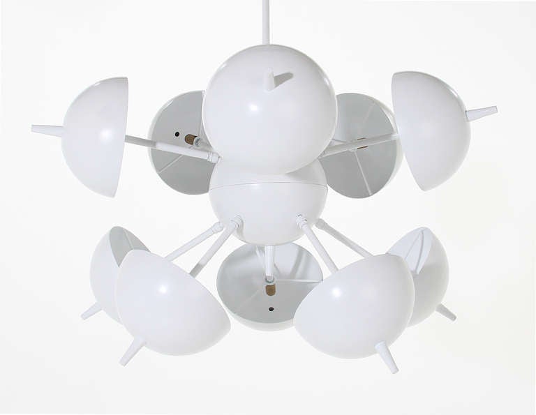 A custom made white chandelier with half-circle shades that can be moved and pointed in the desired position.

Many pieces are stored in our warehouse, so please click on 