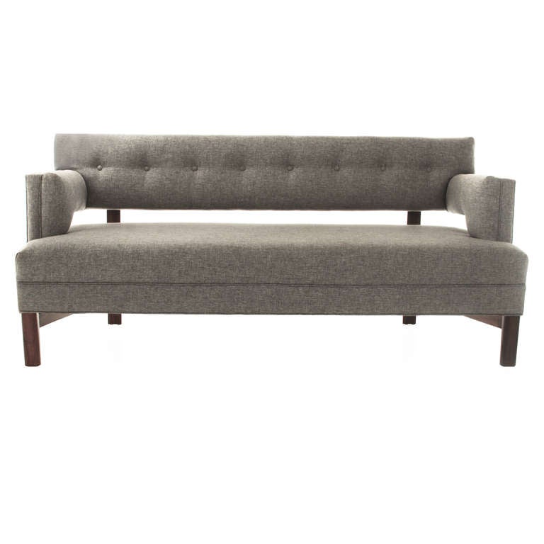 A pair of custom floating-back tufted linen and Walnut sofas by Thomas Hayes Studio. The sofa has a solid Walnut base and elegantly tapered legs. The cushions have been upholstered in a high quality and comfortable gray-blue linen. 

The price is