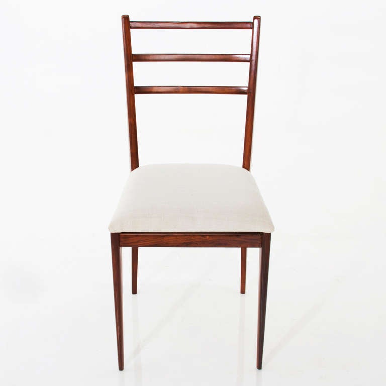 Set of 6 sculptural dining chairs in solid Brazilian hardwood with cream linen seats attributed to Giuseppe Scapinelli. These are beautifully made and restored, but are thin and delicate and are recommended for a more formal setting that may not see