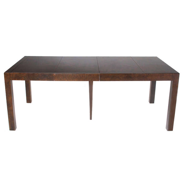 A beautiful example of Milo Baughman's Classic burled walnut dining table with leaves that can also function as a console table. The legs on the centre leaf are removable but provide extra support when the leaf is in. 

Additional