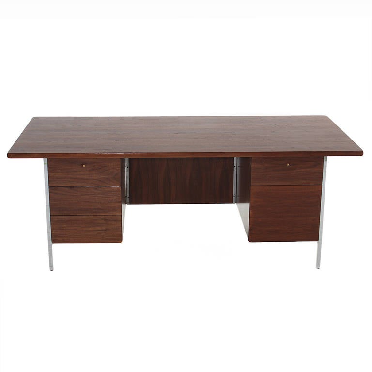 A classic Florence Knoll desk with chrome legs and a walnut top. Each side has drawers for storage.

Many pieces are stored in our warehouse, so please click on CONTACT DEALER under our logo below to find out if the pieces you are interested in