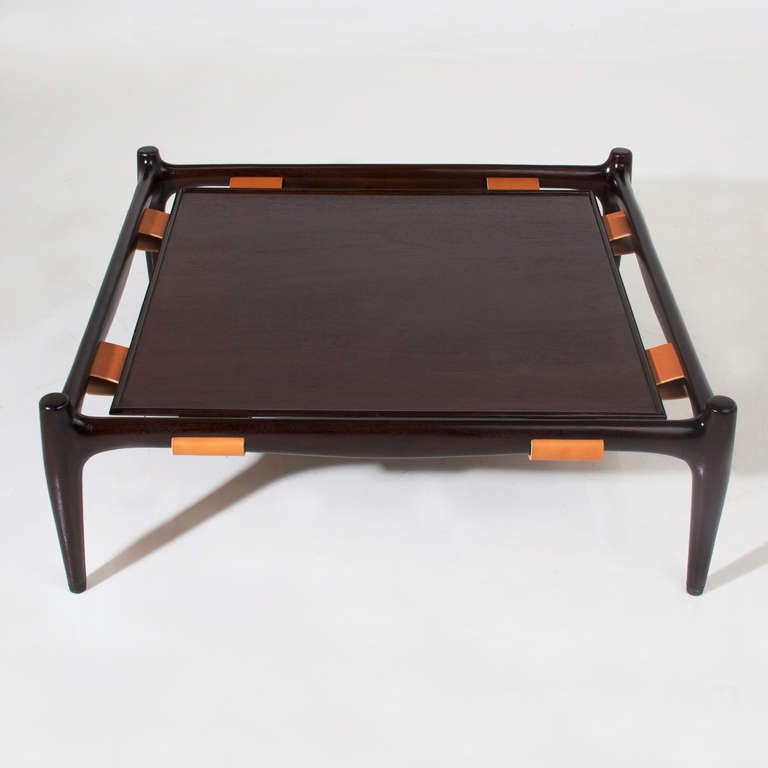 A unique California Craftsman coffee table made from sculpted mahogany frame with tan leather strapping holding the top in place. 

Many pieces are stored in our warehouse, so please click on contact dealer under our logo below to find out if the