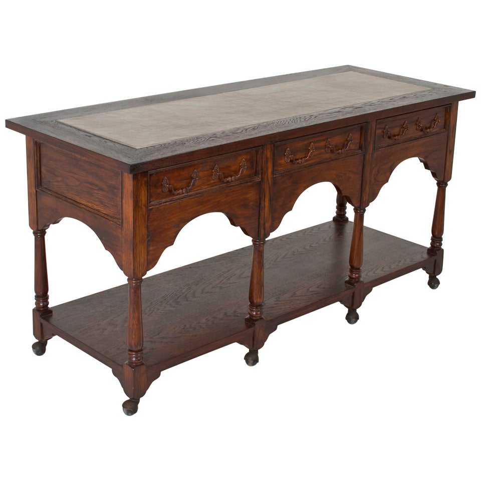 Hollywood Regency French Carved Oak Console Table on Casters For Sale