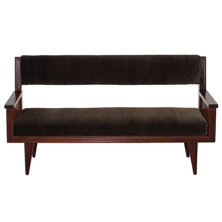 An elegant Brazilian bench in Cerejeira wood by Jacqueline Terpins for Tepperman. The legs are conical shaped and the arms have six connecting joints providing a beautiful detail. The bench is upholstered in a brown mohair fabric. 

Seat Depth: