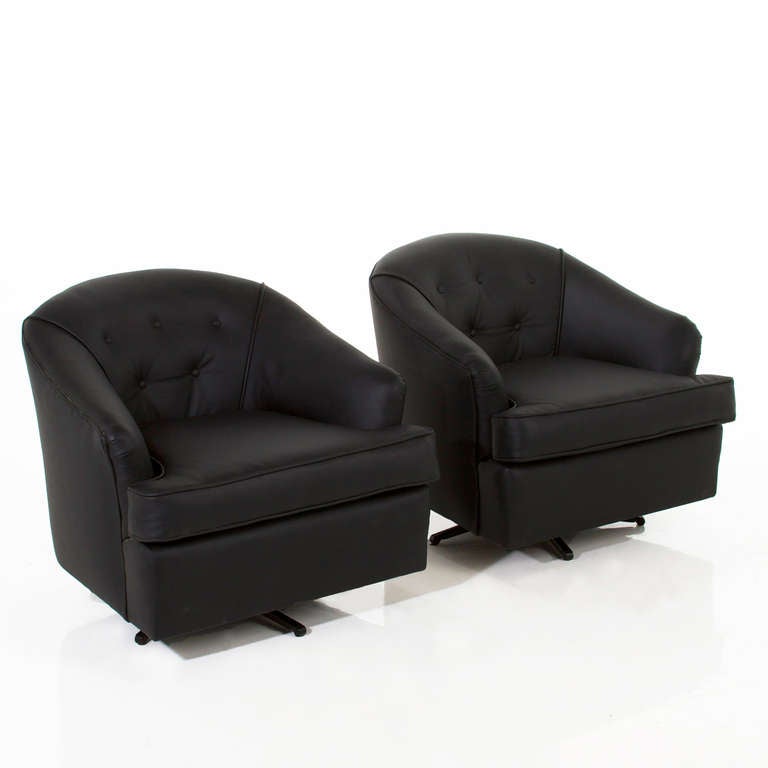 A Classic pair of black leather swivel armchairs with curved and tufted backs and splayed flat black finish metal legs. Super comfortable.


In order to preserve our inventory, after restoration we blanket wrap and store nearly every piece in our