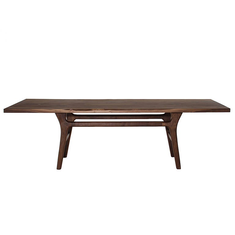 A sculptural dining table in solid wood with curving lines and a wood top inspired by the designs of Italian born Giuseppe Scapinelli from Brazil. 

Available for custom order and the lead time is 6-10 weeks; sometimes we are able to complete