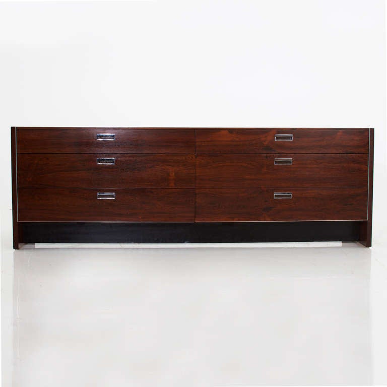 This beautiful rosewood dresser is part of a larger bedroom set by Robert Baron for Glenn of California that we have available. This piece has been refinished and restored, and has a rosewood case with aluminium hardware and aluminium along the