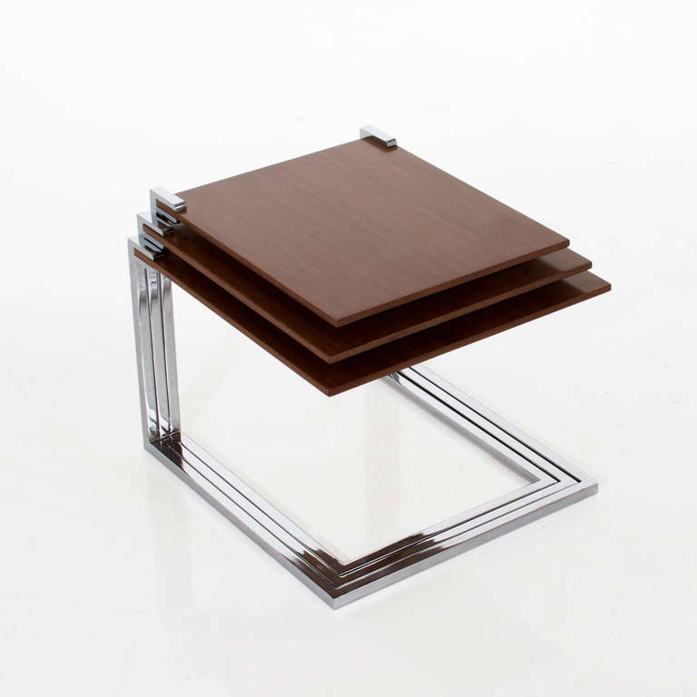 A lovely little set of 3 nesting tables with Walnut tops and cantilevered, floating stainless steel frames. 

Many pieces are stored in our warehouse, so please click on contact dealer under our logo below to find out if the pieces you are