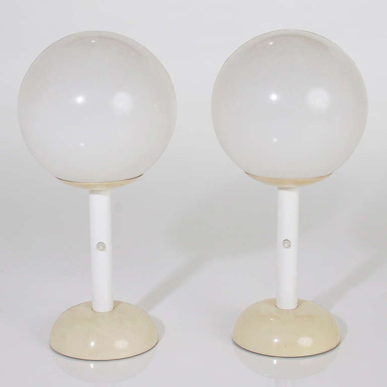 A pair of large vintage white and off-white acrylic globe table lamps suitable for outdoor use. They are all original and with only minor wear consistent with age, are over all in very good workable condition. <br />
