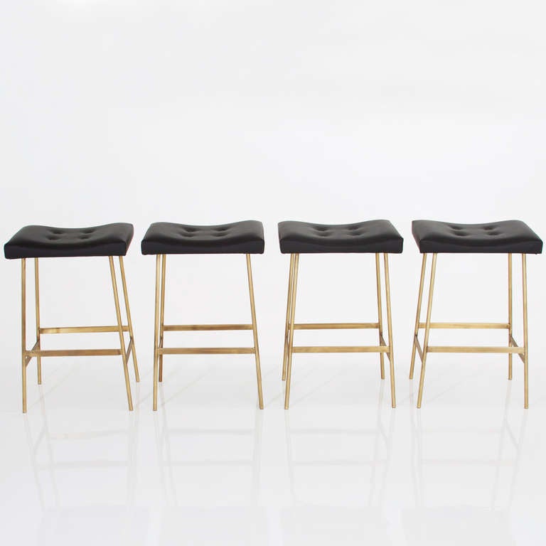 A custom version of the Bunda Bar Stool by Thomas Hayes Studio with solid brass frames and upholstered seat cushions. 

Please look at all pictures, as these stools are individually handmade and the solid brass has some variation. The light patina