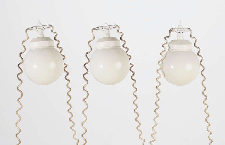 Three acrylic globe lights with small metal hooks strung on a single curly cord that can be hung outside. Acrylic is in good original condition with only some minor fading and yellowing.

Many pieces are stored in our warehouse, so please click on