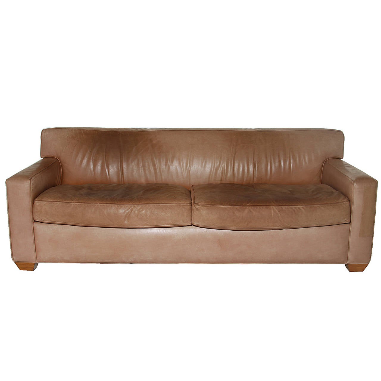 A beautiful Sofa upholstered in original vegetable dyed leather.  It has aged beautifully and has a rich variegation. The leather is a light tan. The legs are prism shaped.

The sofa is in original condition and has minor wear as seen in photos.