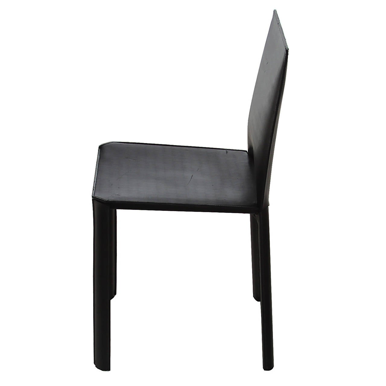 A beautiful single chair from Brazil. The chair is very simply designed and has an elegant look. These chairs are steel frames wrapped in a belt thickness black leather. Leather has been burnished and restored but chair retain original age and