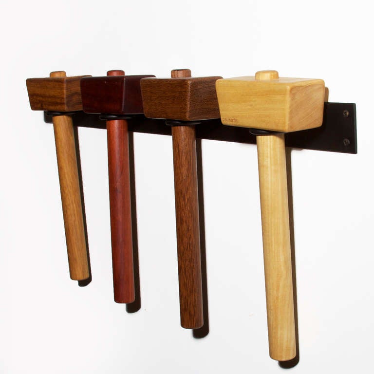 Set of four exotic Brazilian wood mallets by Brazilian designer Rodrigo Calixto. They are held in a wall-mounted display made of solid steel finished in flat black.

Measures: Solid steel wall mount measures 28