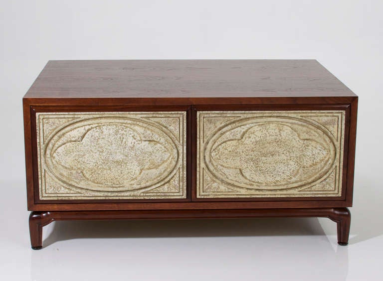 A lovely mahogany coffee table by Monteverdi-Young with sculptural legs and a large storage space with carved Italian gessoed door fronts. The gesso painted finish on the drawer fronts is dappled cream and tan.

Many pieces are stored in our