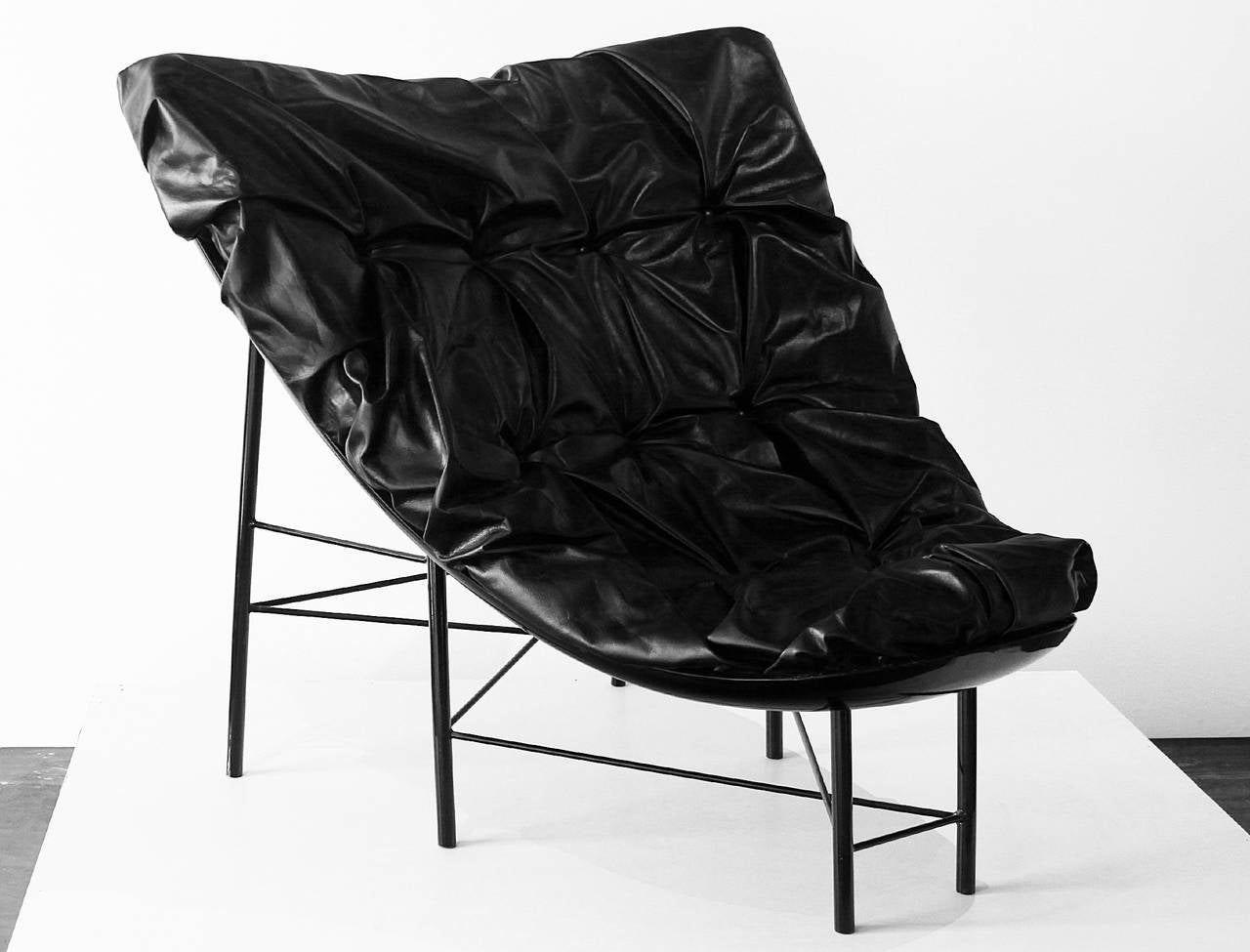 A unique arm chair made out of a Volkswagen Beetle hood by Brazilian artist Alê Jordão. The cushion has been upholstered in a black leather and has been tufted. 

Many pieces are stored in our warehouse, so please click on CONTACT DEALER under