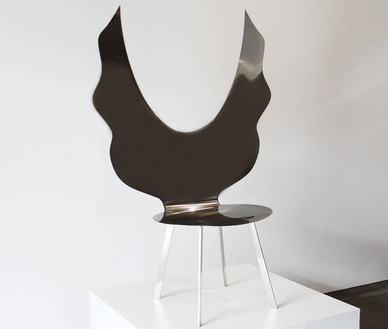 A sculptural chair made of stainless steel by Brazilian designer Alê Jordão. There are two versions of this chair 