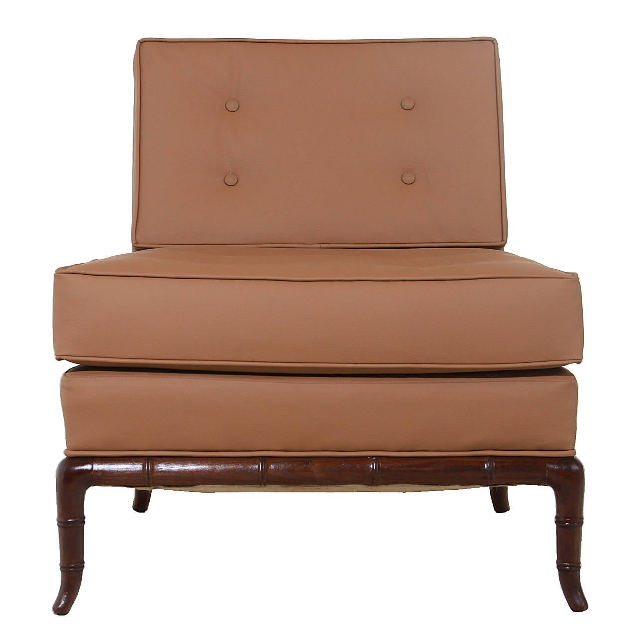 A single slipper chair with mahogany legs by Robsjohn-Gibbings for Widdicomb. The chair is upholstered in a tan leatherette with four tufted buttons on the seat and four tufted buttons on the back.

Measures: Seat depth 21.

 