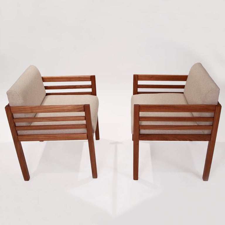 Exlusive Celina prototype Cumaru wood and linen side chairs from Brazil. Arms have four wood slats and are very boxy in design. Seat depth measures 18