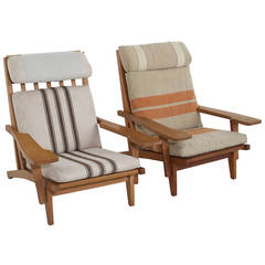 Pair of Hans Wegner GE375 oak and fabric lounge chairs