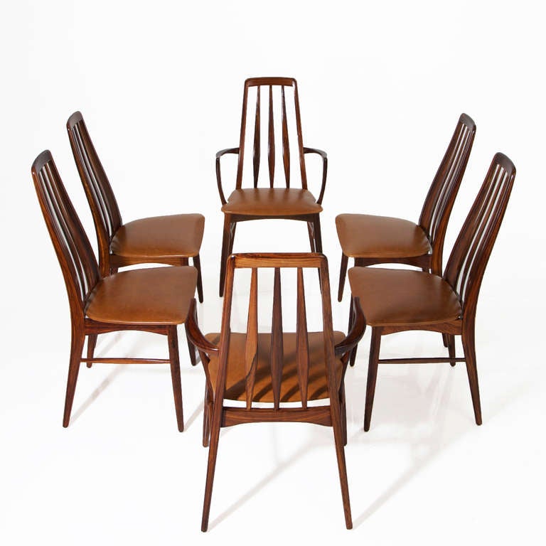A set of 6 sculptural solid rosewood Danish Modern dining chairs by Koefoeds-Hornslet with 2 head chairs with arms and 4 without. The seats are upholstered in a distressed caramel colored leather. 

Many pieces are stored in our warehouse, so