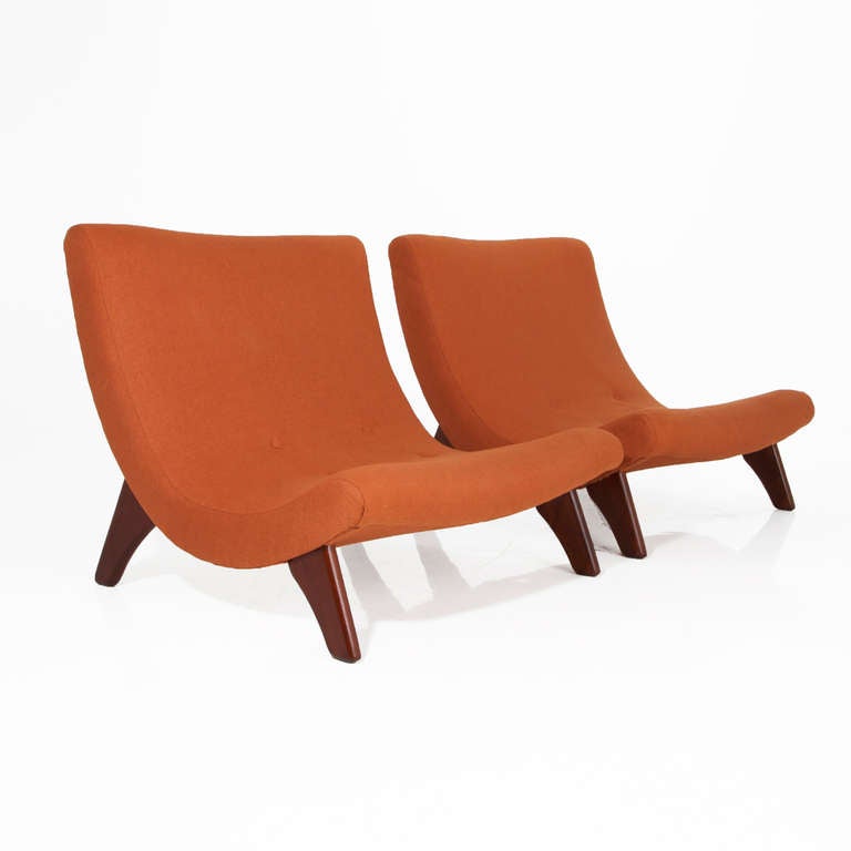 Large scale walnut California design scoop lounge chairs with thick sculptural Walnut legs and burnt orange linen tufted upholstery. These chairs are in the manner of Adrian Pearsall but could be by someone else too. They are very large scale. 