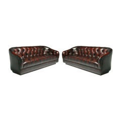 Pair of curved tufted leather sofas by Ward Bennett