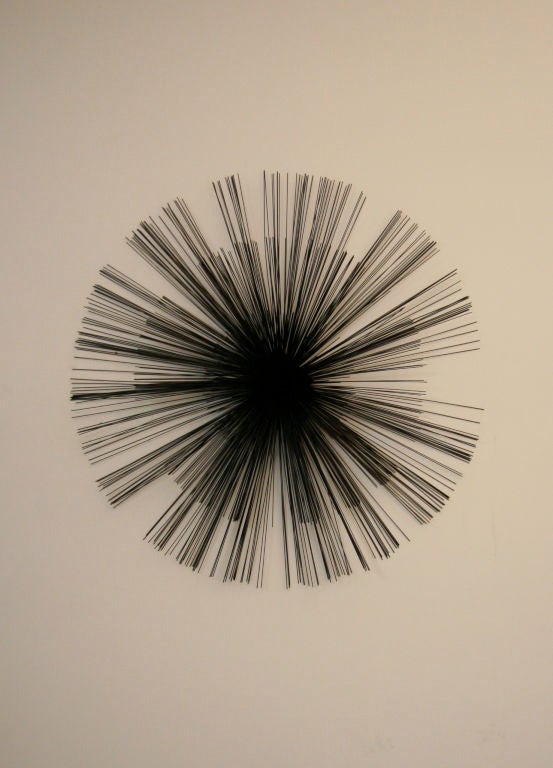 Large metal starburst wall sculpture with bronze painted finish designed by Curtis Jere.