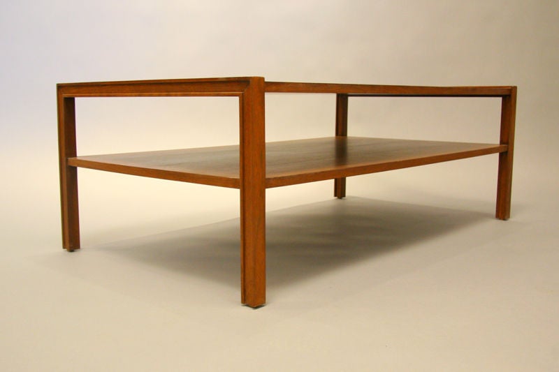 A rectangular walnut coffee table with two shelves and detailed edges designed by Edward Wormley for Dunbar. Sleek and in excellent restored condition.

 
