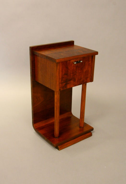 An upright vintage mahogany humidor that can be placed on the floor or on a table top with a curved back support.