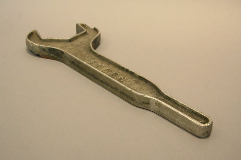 An oversized metal decorative wrench by Jensen. Odd but interesting find. An orangey bronze patina has been applied on one side, see photos for example.

Many pieces are stored in our warehouse, so please click CONTACT DEALER under our logo below