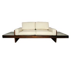 Rosewood and leather settee, floating marble tables by Celina