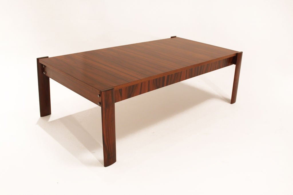 A rectangular coffee table in Brazilian rosewood. The legs are slightly splayed outwards and are wider at the floor than where they support the top.

Many pieces are stored in our warehouse, so please click on 