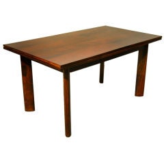 A simple and elegant dining table in rosewood by Jean Gillon