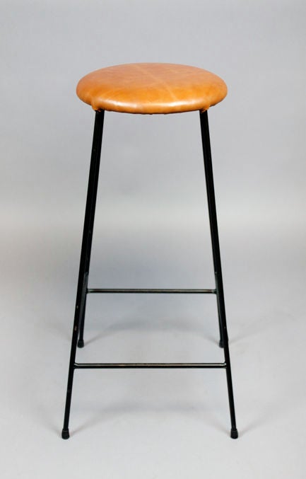 American Set of four caramel leather and iron bar stools