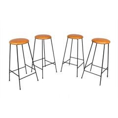 Set of four caramel leather and iron bar stools