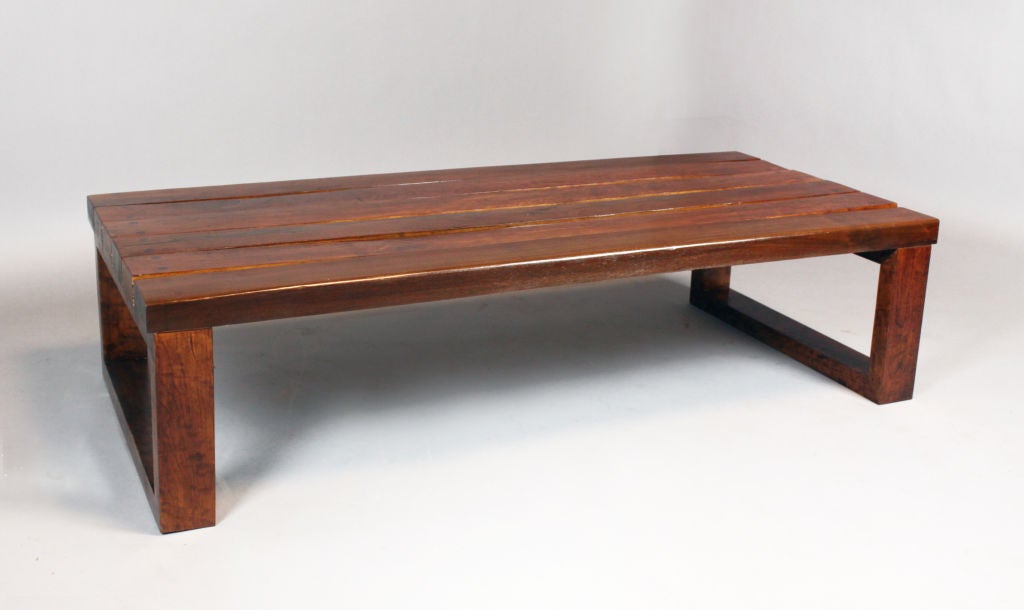 A rectangular coffee table made out of rustic planks of redwood refinished with a slight gloss lacquer finish.
Many pieces are stored in our warehouse, so please give us a call at (323) 463-4434 or email us at info@thomashayesgallery.com to find out
