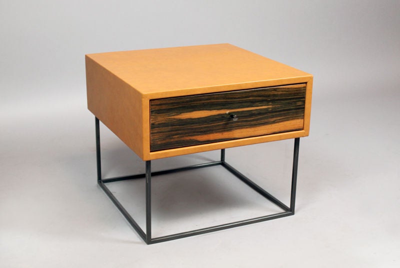 The Deane side table by Thomas Hayes Studio features a leather wrapped case with wood drawer front on a solid steel or brass base. The single or double drawers are made with the highest quality soft-close mechanisms that open with a variety of