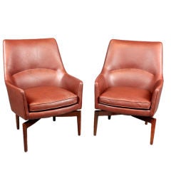 Pair of leather and walnut lounge chairs by Jens Risom