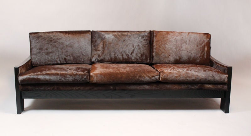 Ebonized oak, Rosewood and exotic hardwood sofa upholstered in brown hair on hide. Most of the frame has been ebonized with Rosewood detailing on the tops of the arms. Please request sample of hair on hide; the color is subtle and has