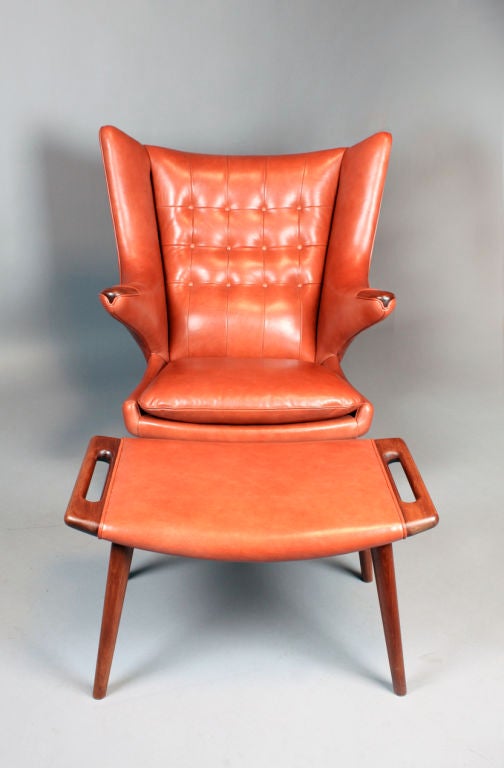 This chair has been professionally reupholstered by an expert who knows how to preserve the lumbar support original to these chairs.  It is a very comfortable chair.  The upholstery is a soft supple brick colored leather with a matte finish. The