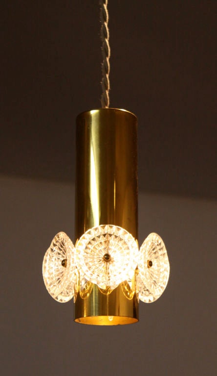 Polished brass and flower-like cut glass pendant lights from the 1960's. Priced individually; seven total are available.

Many pieces are stored in our warehouse, so please click on CONTACT DEALER under our logo below to find out if the pieces you