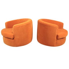 Pair of round swivel tub chairs by Milo Baughman