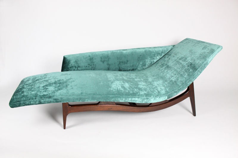 An elegant chaise longue on sculptural solid Mahogany base with curved seat upholstered in a turquoise silk velvet. This lounge is incredibly well constructed.  It looks very much like a Dunbar piece both in construction techniques and materiality.