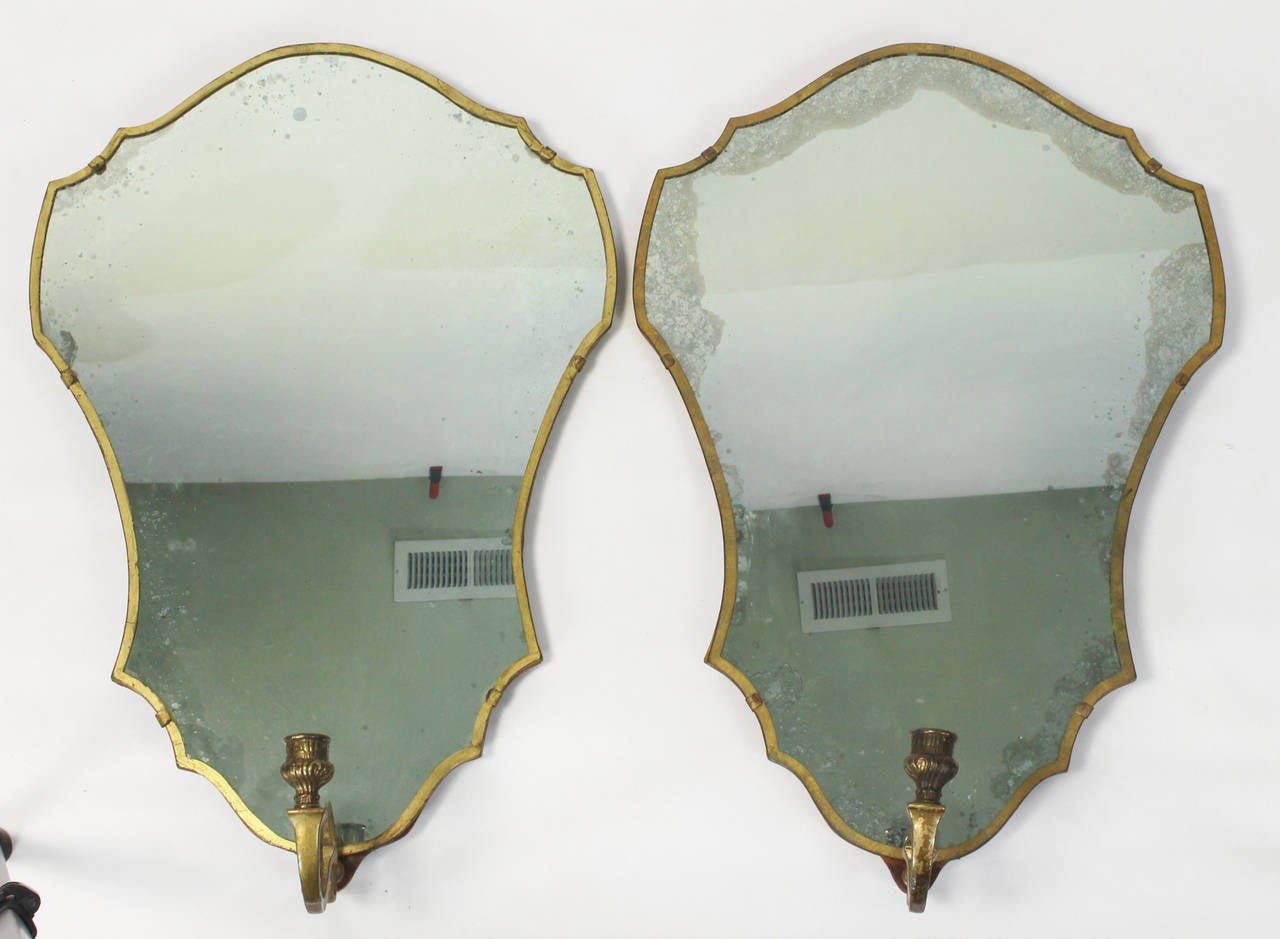 A pair of large and elegant Venetian mirror backed wall sconces dating from the 1920's. The arms can accept candles or could easily be wired for electricity.