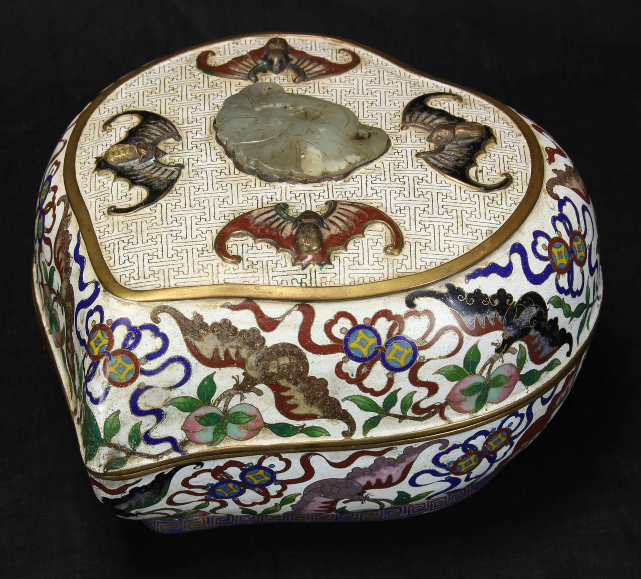 A large late 19th century Chinese cloisonné peach-shaped box with bat decoration and set with jade or jadeite stone. The box is elaborately decorated inside and on the bottom. Bats and peaches symbolize fortune and longevity in Chinese culture.