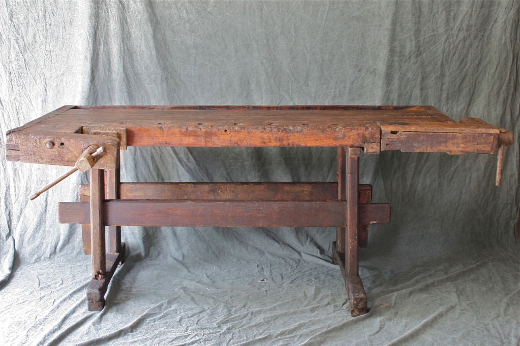 This rustic carpenter's workbench is make of oak and ash with pine legs. The hardware, vice and clamp are all original.