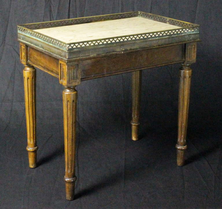 Early 20th C. French carved walnut occasional table with ivory marble top and pierced bronze gallery tray on nicely carved and fluted legs.