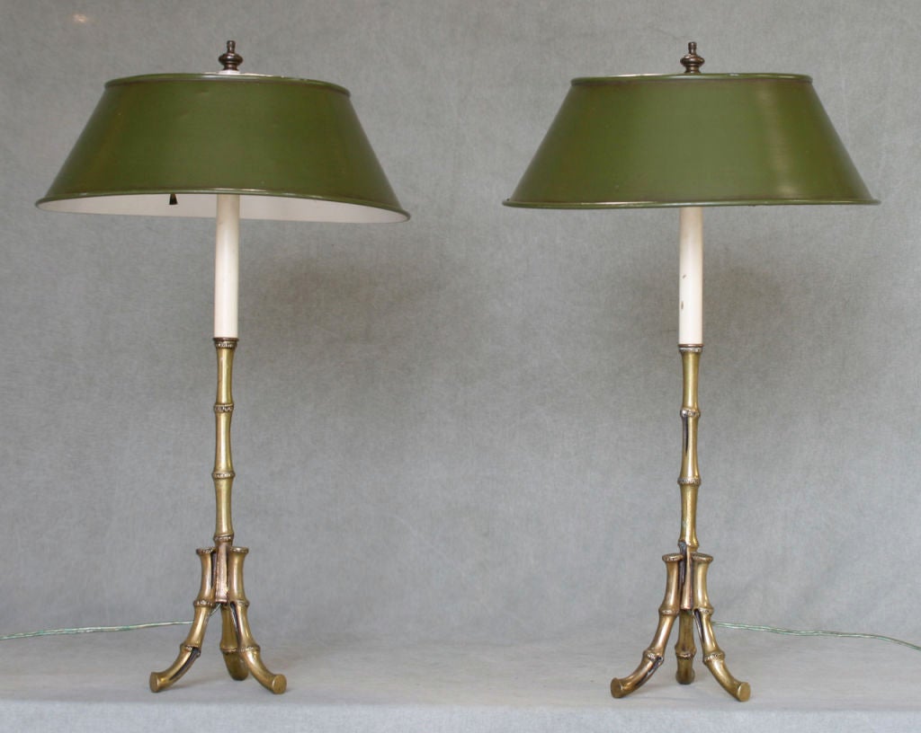 A lovely pair of beautifully cast brass faux bamboo table lamps with original painted green tole shades attributed to Maison Bagues.