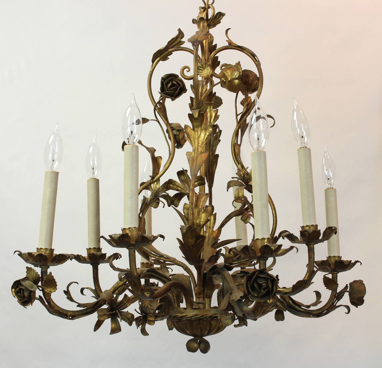 A large Italian gilt iron eight-light chandelier dating from the 1960s decorated with trailing vines and flowers.